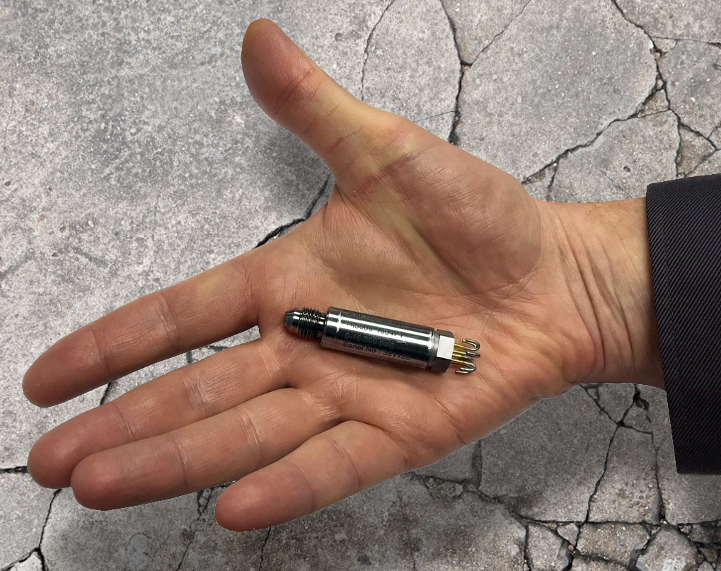 a mans hand holding out the HI5000 downhole pressure transmitter